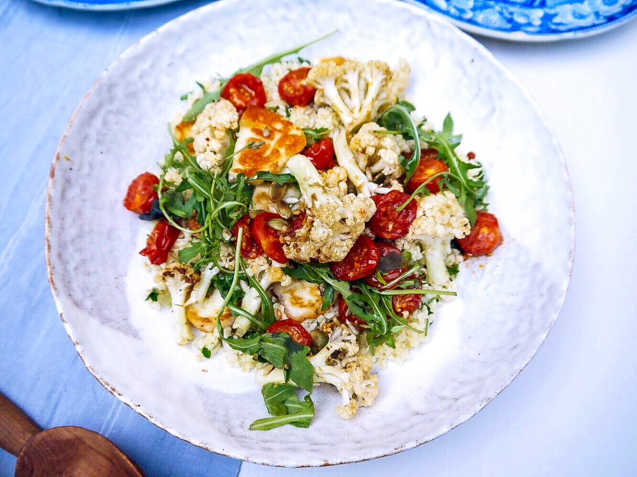 Harissa tomatoes with cauliflower and halloumi 