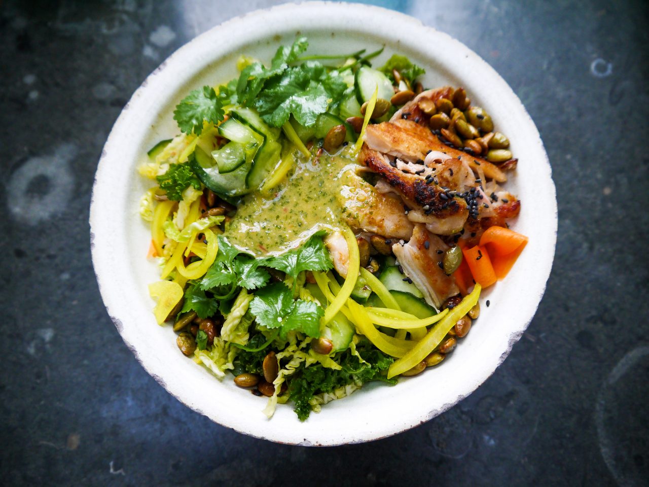 Vegan rainbow bowl with miso dressing and crispy tofu