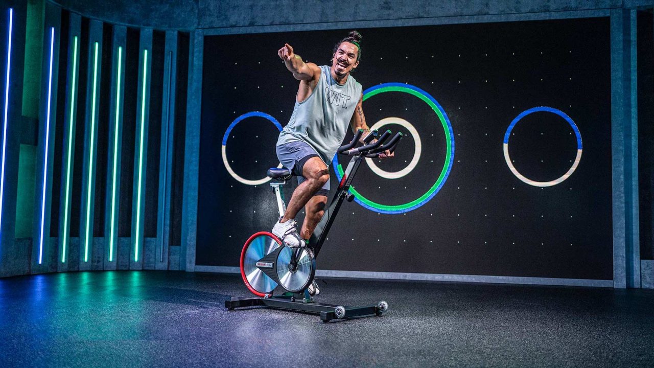 Fiit trainer Gus demonstrating an indoor bike workout