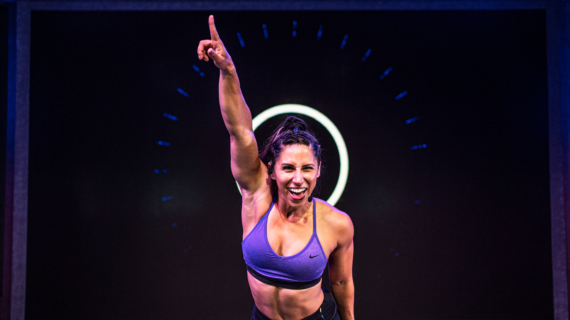 Fiit trainer and three-time American Ninja Warrior Angela Gargano pointing to the sky
